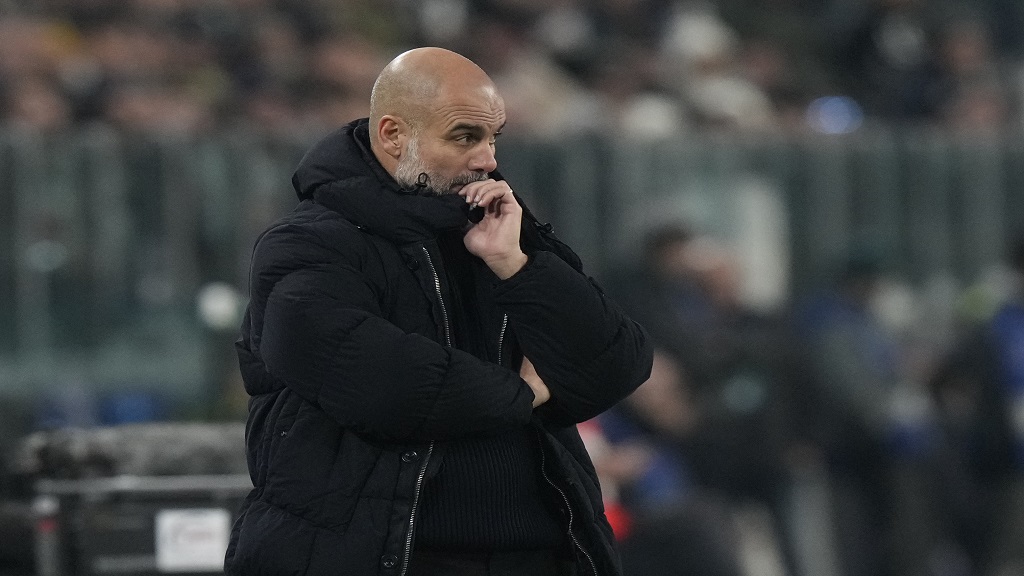 Manchester City's head coach Pep Guardiola watches his players during the Champions League, opening phase football match against Juventus at the Allianz stadium in Turin, Italy, Tuesday, Wednesday, Dec.11, 2024. (AP Photo/Luca Bruno).