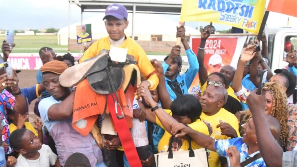 Jockey Raddesh Roman is surrounded by cheering fans after winning his first jockeys' championship at Caymanas Park on Saturday, December 28, 2024.