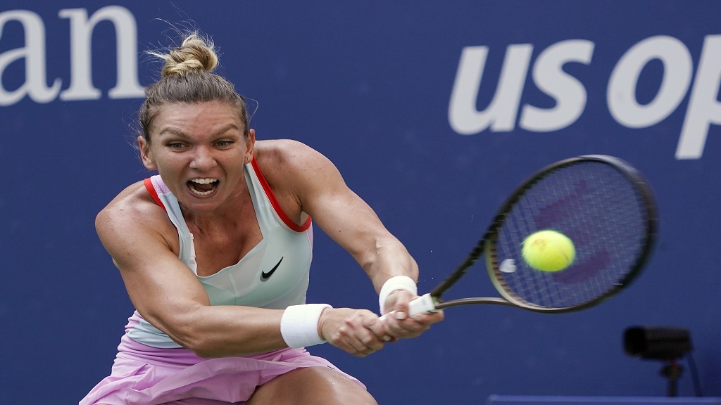 Simona Halep, of Romania, returns a shot to Daria Snigur, of Ukraine, during the first round of the U.S. Open tennis tournament, Aug. 29, 2022, in New York. (AP Photo/Seth Wenig, File).