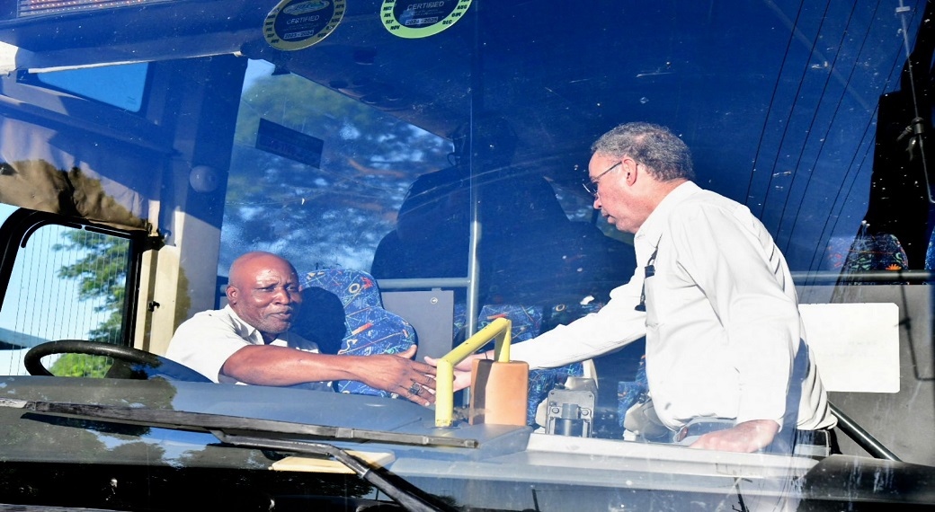 Minister of Science, Energy, Telecommunications and Transport, Daryl Vaz (right), shakes hands with Jamaica Urban Transit Company (JUTC) driver, Mark Savage, who operates Bus #702 from Morant Bay in St Thomas to Kingston.