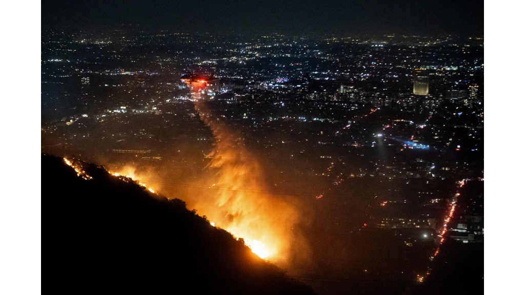 Water is dropped by helicopter on the burning Sunset Fire in the Hollywood Hills section of Los Angeles, Wednesday, Janauary 8, 2025. Photo: AP/Ethan Swope)
