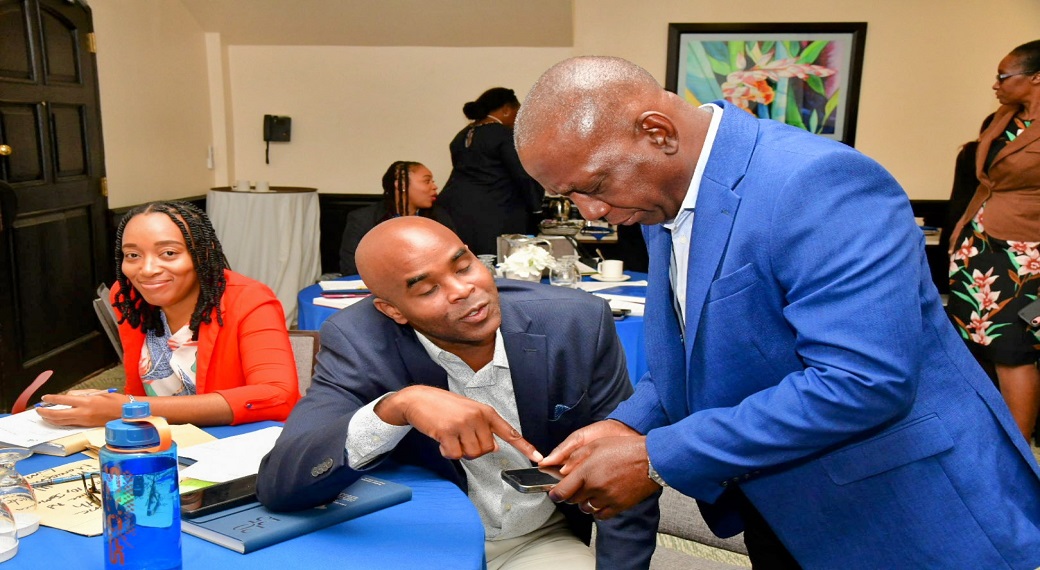 Executive Director of the National Solid Waste Management Authority (NSWMA), Audley Gordon (right), engages with Regional Operations Manager, Western Parks and Markets (WPM) Waste Management Limited, Edward Muir (centre), at the Authority’s special operations meeting on Monday (January 6) at the Courtleigh Hotel in Kingston. At left is Corporate Services Director, NSWMA, Sheenique Johnson.