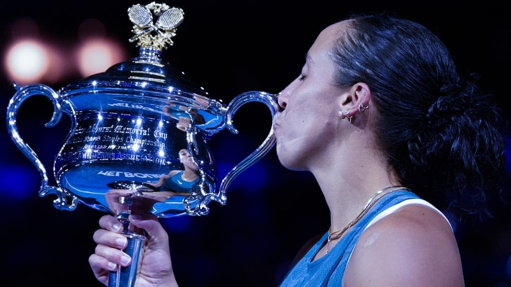 Madison Keys of the U.S. kisses the Daphne Akhurst Memorial Cup after defeating Aryna Sabalenka of Belarus in the women's singles final at the Australian Open tennis championship in Melbourne, Australia, Saturday, Jan. 25, 2025. (AP Photo/Asanka Brendon Ratnayake).