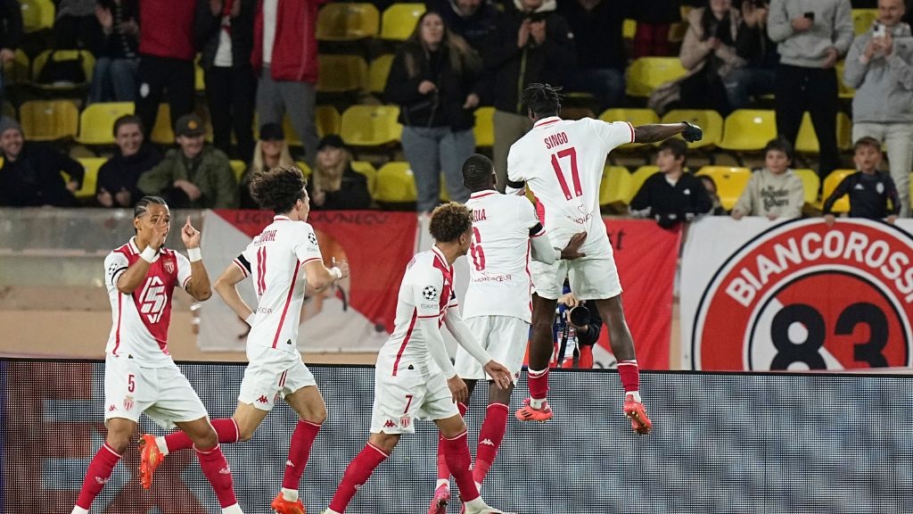 Monaco's Wilfried Singo, right, celebrates after scoring during a Champions League opening phase football match against Aston Villa at the Louis II stadium in Monaco, Tuesday, Jan. 21, 2025. (AP Photo/Laurent Cipriani).