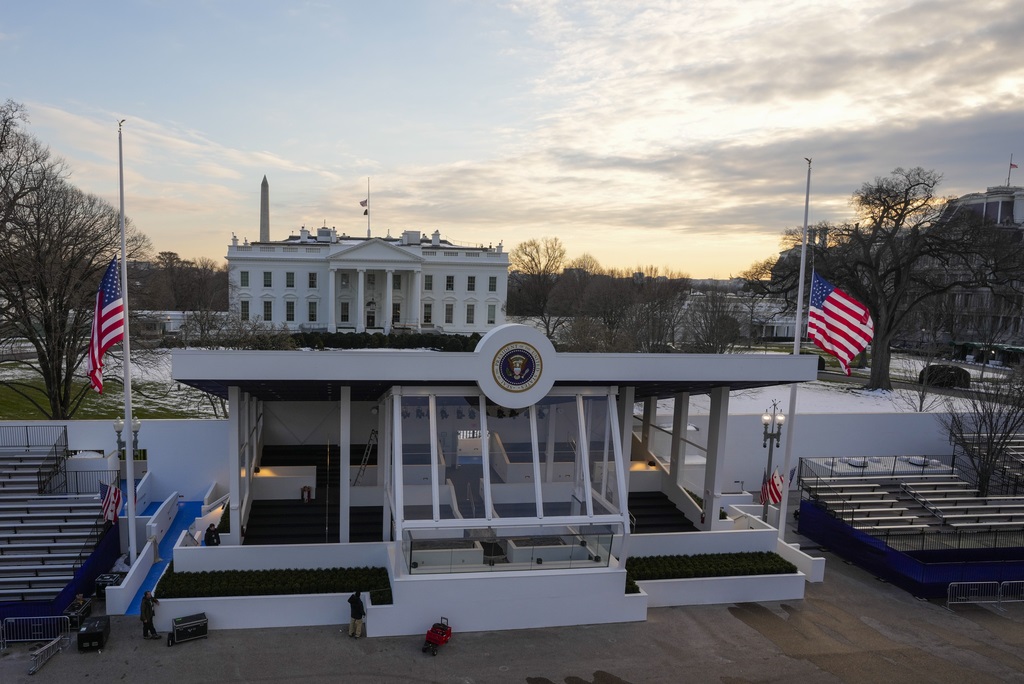 Workers continue with the finishing touches on the presidential reviewing stand on Pennsylvania outside the White House Thursday, Jan. 16, 2025, in Washington, ahead of President-elect Donald Trump's inauguration. (Jon Elswick via AP)
