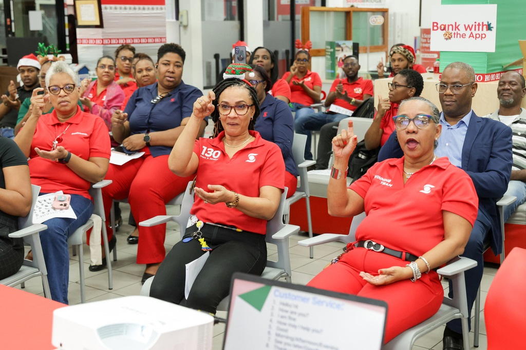 Scotiabank staff members are all smiles as they wrap sign language training session.