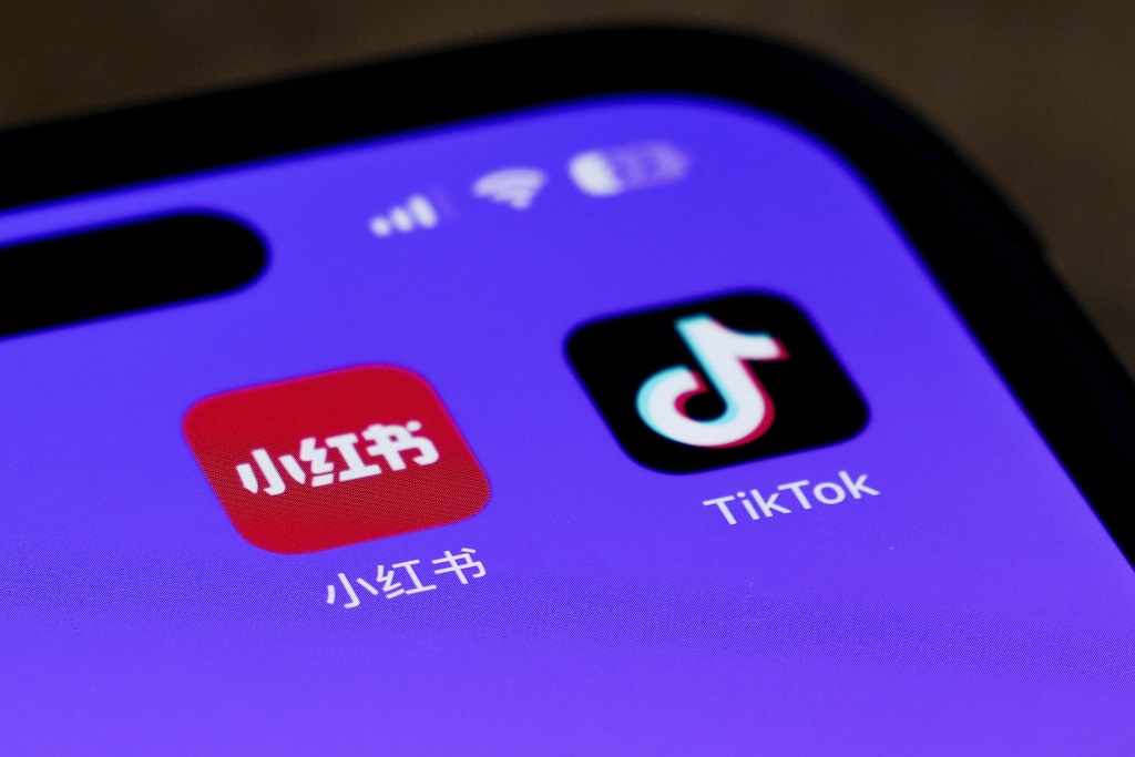 Icons for the smartphone apps Xiaohongshu and TikTok are seen on a smartphone screen in Beijing, Tuesday, Jan. 14, 2025. (AP Photo/Andy Wong)
