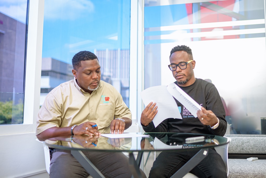 Kintyre Holdings CEO Tyrone Wilson (right) and NGAP Limited, led by CEO Wayne Morrison go over the joint-venture agreement.