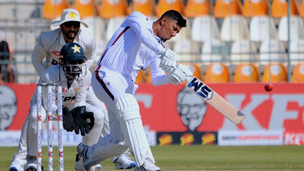 West Indies Gudakesh Motie, front, plays a shot as Pakistan's Mohammad Rizwan, center, and Salma Ali Agha watch during the day one of the second cricket test match in Multan, Pakistan, Saturday, Jan. 25, 2025. (AP Photo/Asim Tanveer).