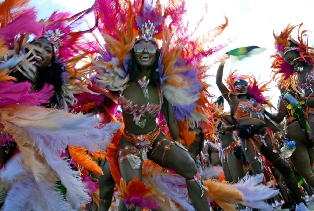 Masqueraders dance during the Caribbean Carnival parade in Toronto, Canada, Saturday, July 30, 2022. The 55th annual parade returned to the streets after the COVID-19 pandemic cancelled it for two years in a row. (AP Photo/Kamran Jebreili)