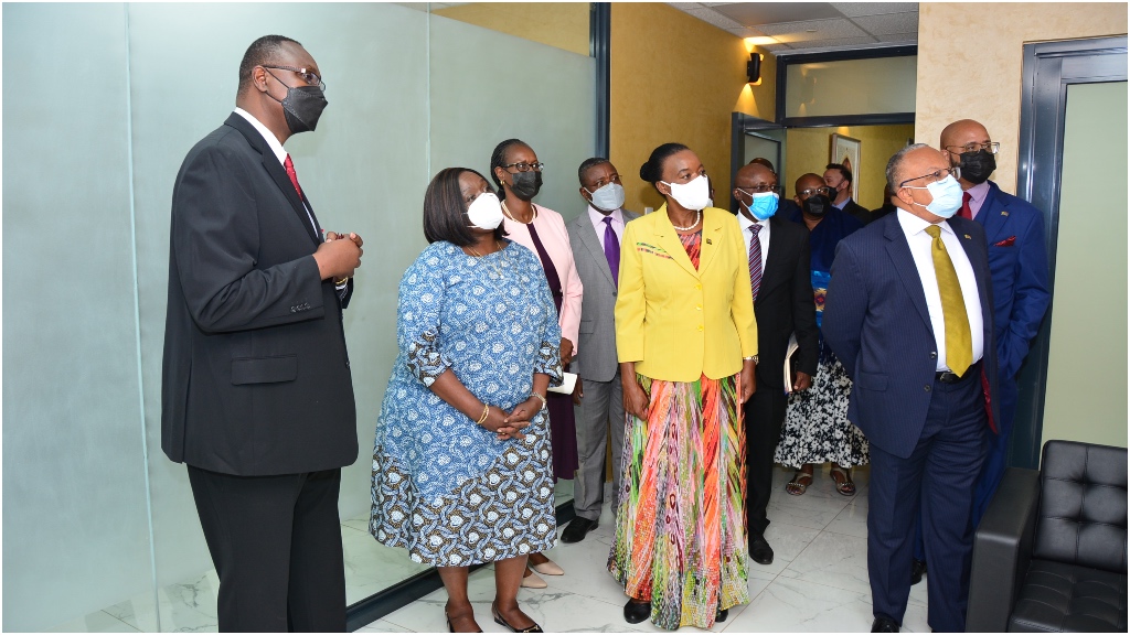 Architect for the offices, Paul Macharia Mwithaga (left) explains some of the design features to the delegation.