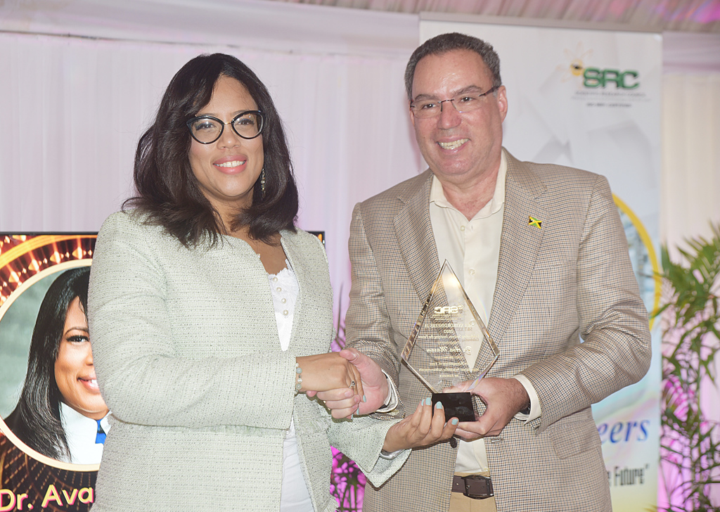 Dr Ava Maxam receives her award from Science and Technology Minister Daryl Vaz