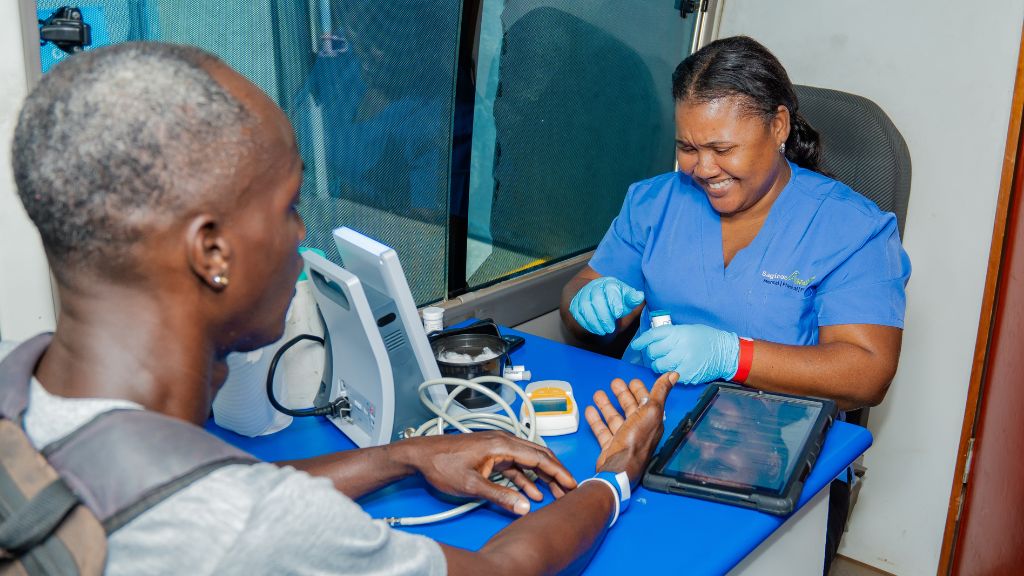 An attendee at the Spectrum Management Authority's inaugural health and wellness fair awaits a medical check.