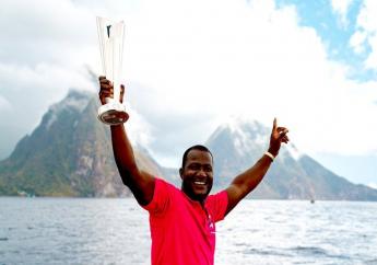 West Indies head coach Daren Sammy poses with the T20 World Cup Trophy in front of the Pitons in St Lucia. (Photo credit - CWI Media)