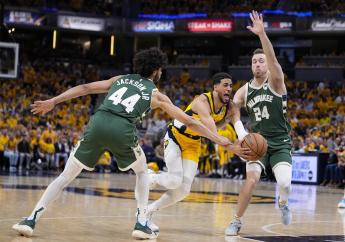 Indiana Pacers guard Tyrese Haliburton (0) drives between Milwaukee Bucks guard Andre Jackson Jr. (44) and guard Pat Connaughton (24) during the second half in Game 2 in an NBA basketball first-round playoff series, Friday, April 26, 2024, in Indianapolis. (AP Photo/Michael Conroy).

