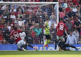 Arsenal's Leandro Trossard (centre) scores his side's opening goal during the English Premier League soccer match between Manchester United and Arsenal at the Old Trafford Stadium in Manchester, England, Sunday, May 12, 2024. (AP Photo/Dave Thompson)