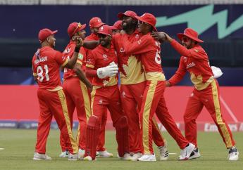 Canada's Aaron Johnson, third from right, is congratulated by teammates after taking the catch to dismiss Ireland's Curtis Campher for 4 runs during an ICC Men's T20 World Cup cricket match at the Nassau County International Cricket Stadium in Westbury, New York, Friday, June 7, 2024. (AP Photo/Adam Hunger).