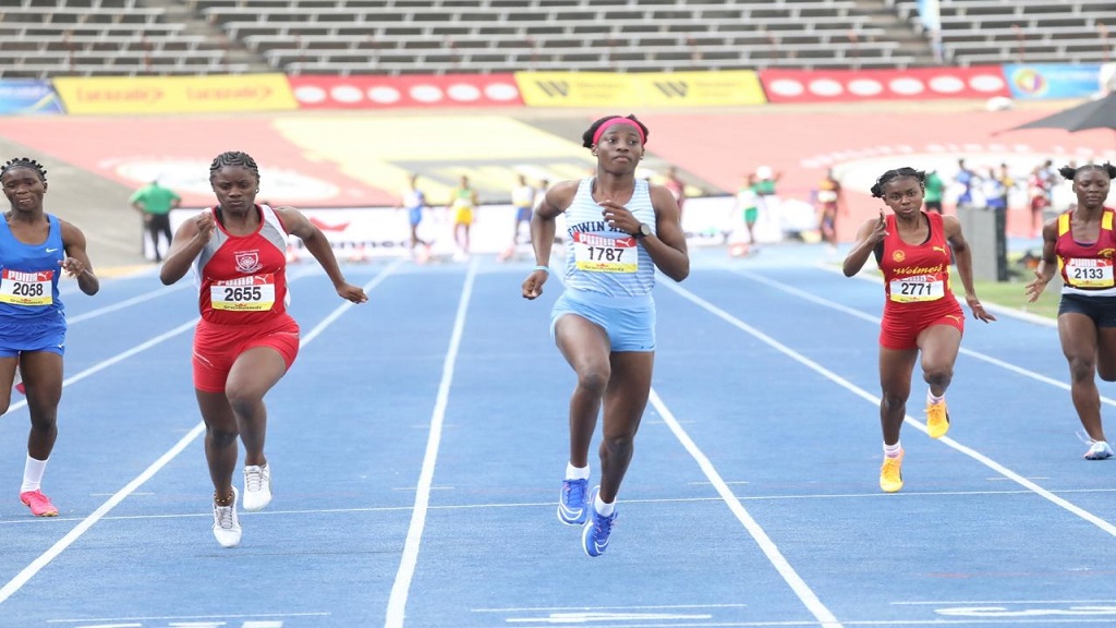  Theianna-Lee Terrelonge (centre) of Edwin Allen wins heat one of the Girls' Class Two 100m at the the ISSA/GraceKennedy Boys’ and Girls’ Athletics Championships at the National Stadium on Tuesday, March 19, 2024. Terrelonge headlines Jamaica's team in St George’s, Grenada, for the 51st Carifta Games, starting today. (PHOTO: Marlon Reid).